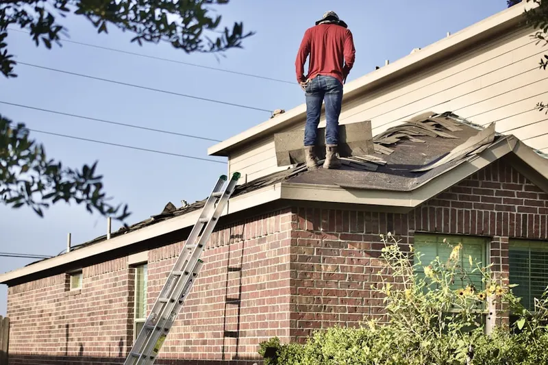 Professional roofer working on a residential roof in Kersey